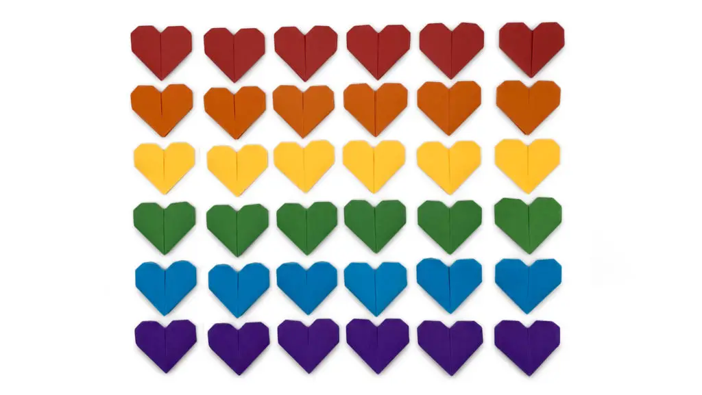 traditional origami hearts lined up like the rainbow pride flag