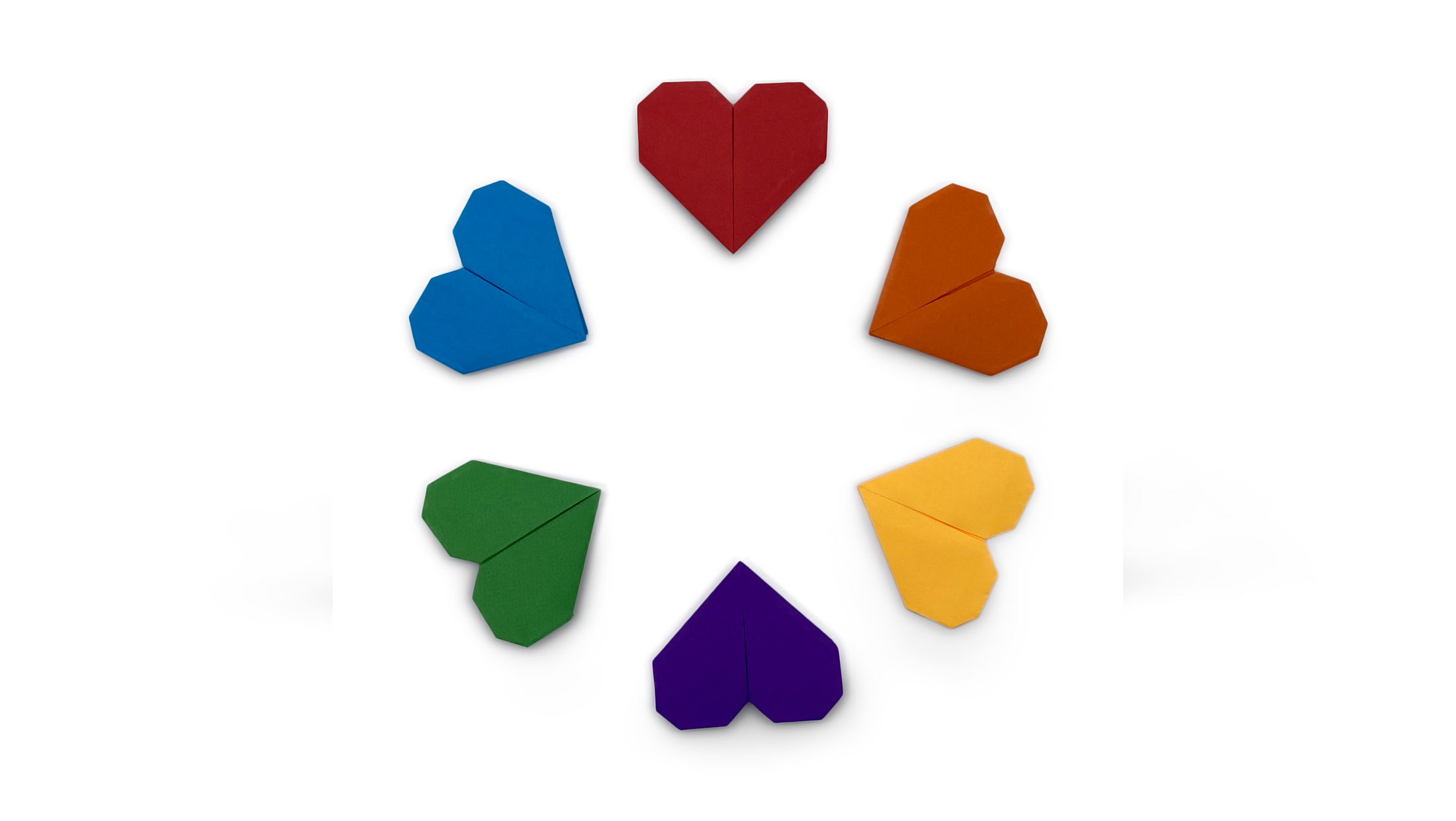 easy traditional origami hearts in a rainbow of colours arranged in a circle