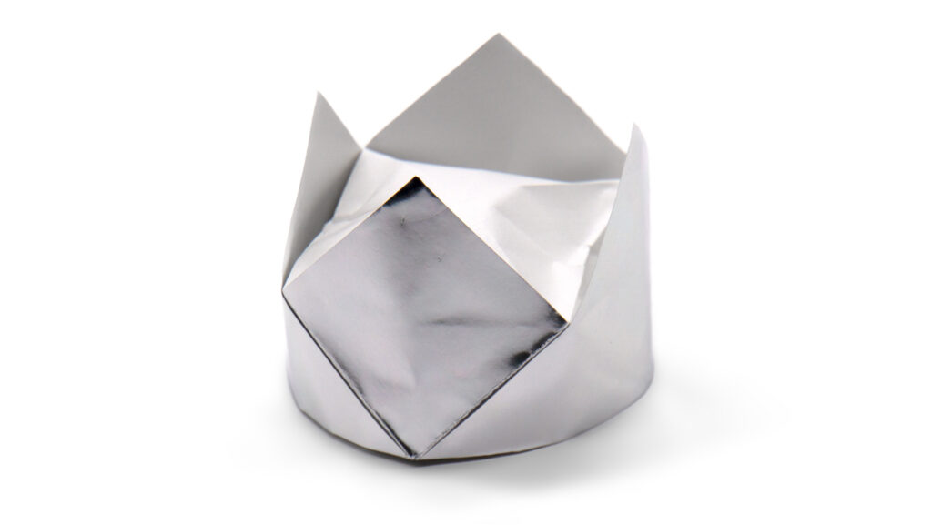 traditional origami crown folded with metalic silver paper
